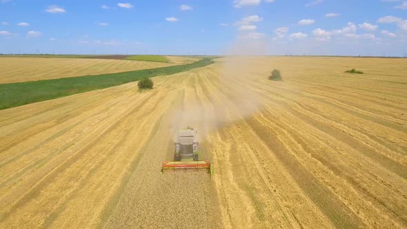 Aerial Shot of Combine Harvester Working in Field alt