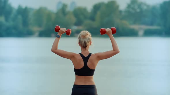 Fitness Exercising With Dumbbells. Cardio Fitness Training.Sportswoman Lifting Weight Fitness alt