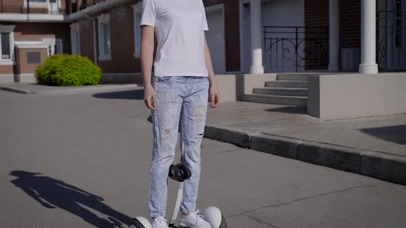 Attractive Happy Woman Rides on a Gyrocopter in the City Area alt