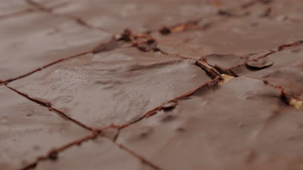 Choco cake glazed surface close-up cracks after baking 4K 2160p 30fps UltraHD pan video - Chocolate  alt