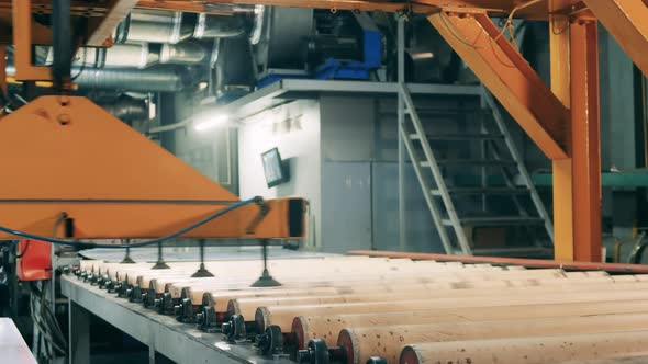 Transporting Machine Is Moving Above the Rolling Conveyor alt