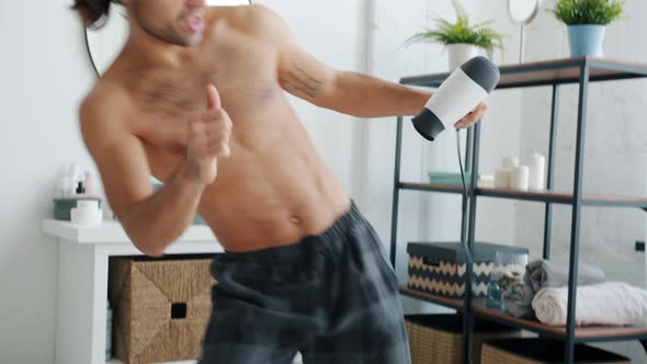 Energetic Young Brunet Dancing in Bathroom and Singing in Blow Dryer Having Fun Alone alt