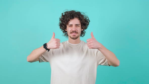 Portrait of Satisfied Bearded Man with Curly Hair Doing Thumbs Up Gesture alt