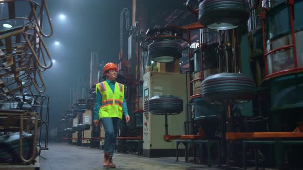 Focused Woman Supervisor Walking at Huge Modern Production Facility Warehouse alt