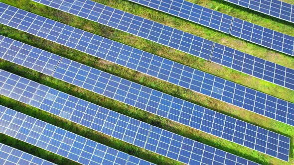 Drone fly over solar farm, renewable energy from solar. alt