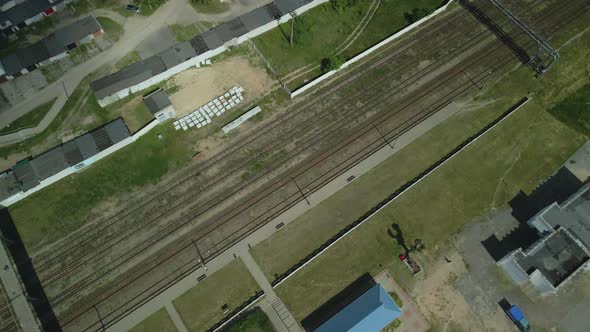 Flight Over Suburban Railway Station. Railroad Tracks And Sleepers Are Visible. alt