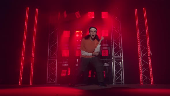 Professional Young Hip-hop Dancer, Dancing in Dark Studio in the Green and Yellow Fog. Hip Hop alt