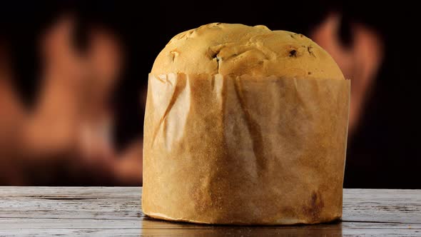 Italian panettone on wooden table fire in the background