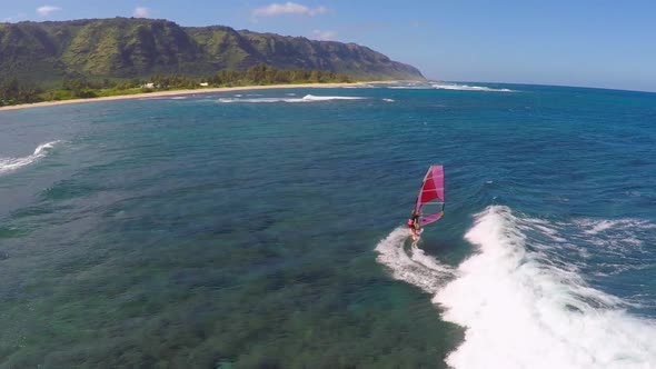Aerial view of a man windsurfing in Hawaii alt