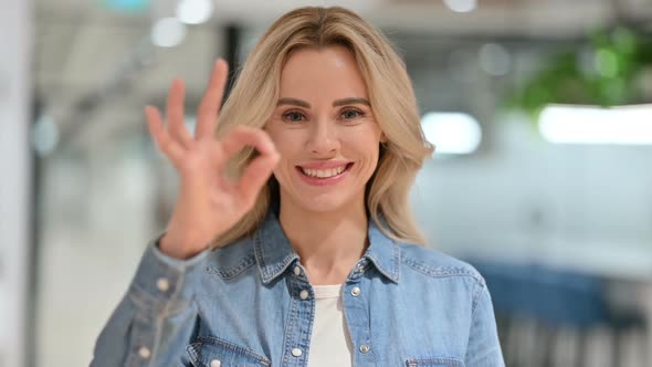 Appreciative Young Woman with OK Sign By Hand alt