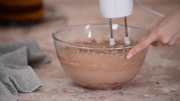 Mixing Chocolate Cream for Cake with Electric Mixer