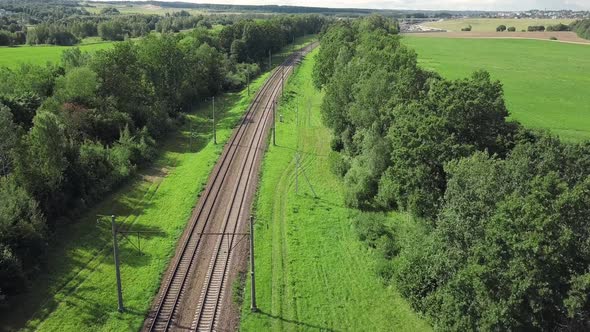 Train Way Through Green Grassed Countryside, Aerial.