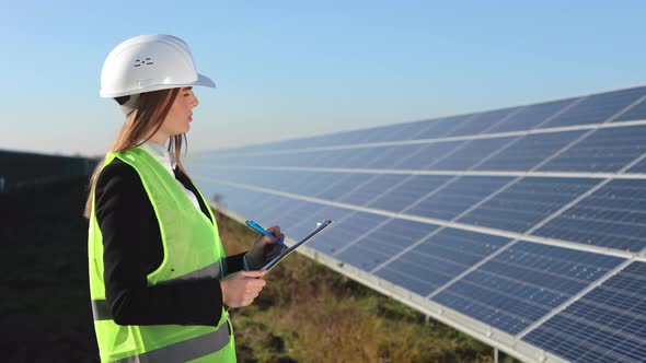 The Female Engineer is Writing the Data to a Document alt