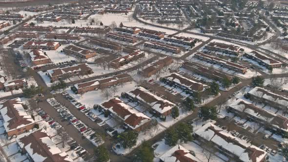 Snowfall Over Apartment Complex Residential with Snow Covered Roofs Houses in USA Countryside alt