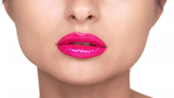 Portrait of Funny Cheerful Young Woman Posing on Camera with Lips Covered By Pink Shining Lipstick alt