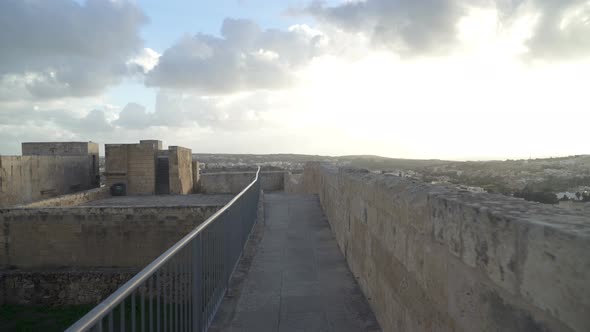 Defensive Cittadella Fortress Wall Leading to Guard Tower on Sunny Winter Day in Gozo Island