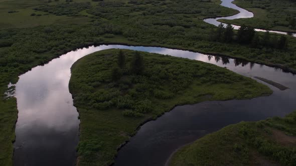 Slowly flying backwards from over river alt