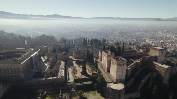 Alhambra citadel with landscape shrouded in fog, Granada in Spain. Aerial panoramic view