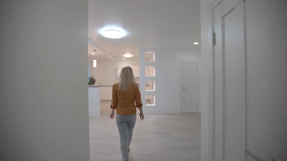 Moving in New Apartment Woman with Keys Walks Into Her New Flat Empty White Rooms New Home