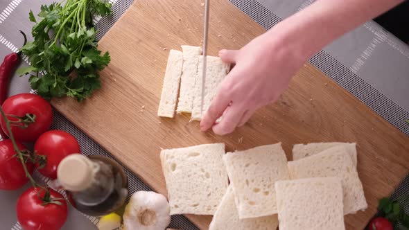 Making Caesar Salad Croutons By Slicing Toast Bread alt