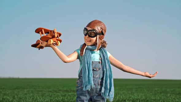 Happy Child Playing with Toy Airplane against Summer Sky Background