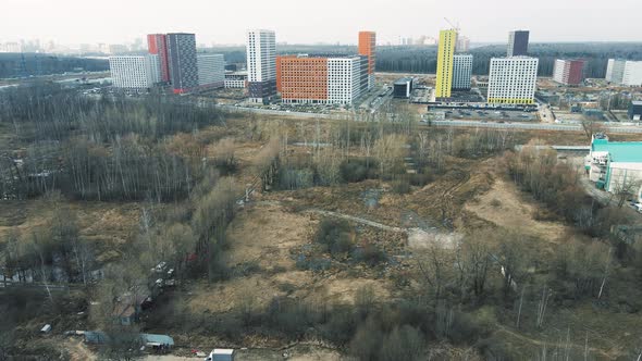 A Bird'seye View of Highrise Buildings Near a Forest alt