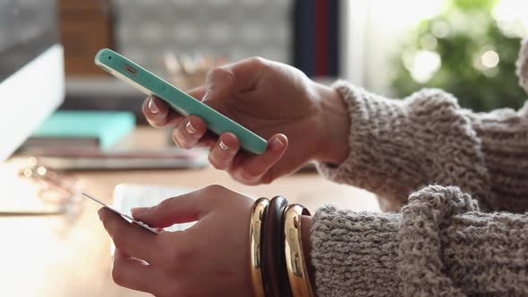 Young Woman Buys Online Using her Phone alt