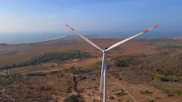 Aerial Shot of a Group of Wind Turbines in a Semidesert Environment alt