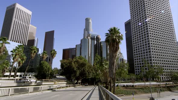 Wide pan of sky scrapers and traffic from bridge in Los Angeles alt