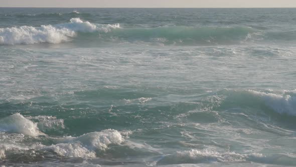Huge Ocean Waves Roll on Beach Against Blue Sky Slow Motion alt