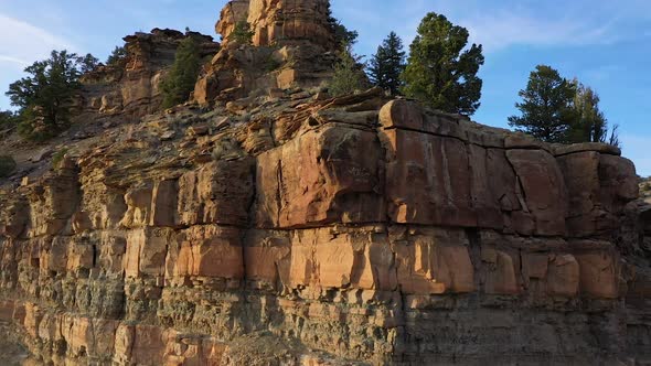Viewing layers of dirt and rocks below the ground flying over cliff alt