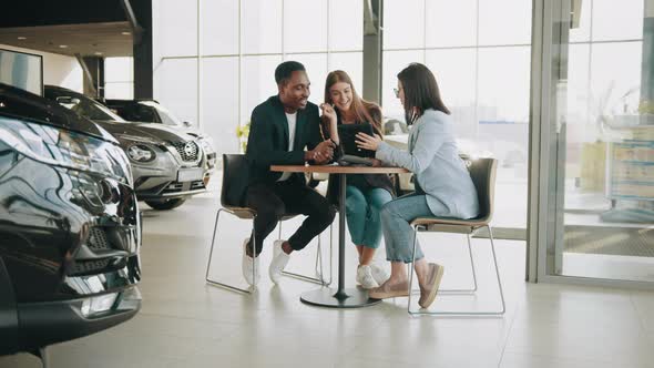 Female Auto Seller with Tablet in Hands Providing Professional Consultation for alt