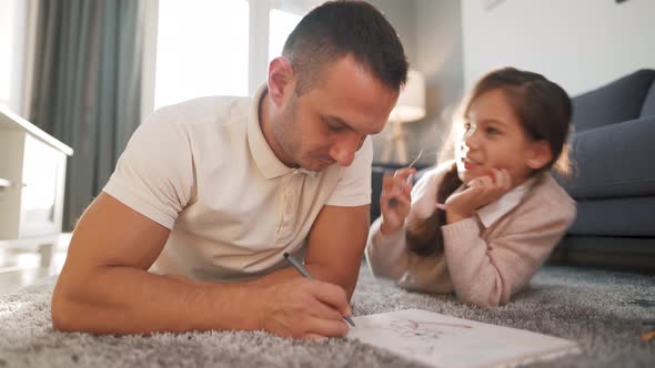 Father and Daughter Communicate, Having Fun and Painting Together. Concept of a Happy Family and alt