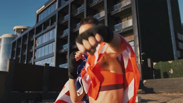 Young Female in Sportswear Wrapped in Flag of USA alt