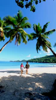 Couple Man and Woman on Vacation Seychelles Mahe Seychelles Tropical Beach with Palm Trees and a alt