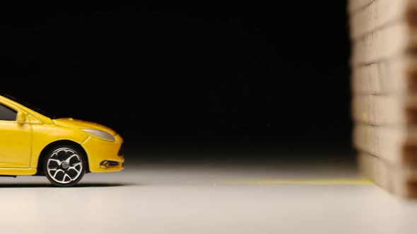 Crash test of yellow toy car