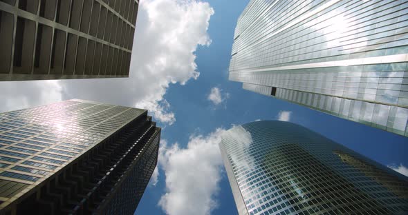 Looking Up at Business Skyscrapers Buildings in Dowmtown, Clouds Rolling in Sky and Reflections on alt