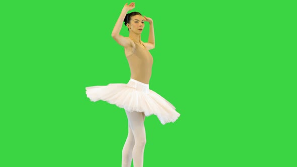 Young Ballerina Makes Several Turns En Pointe Raising Arms on a Green Screen Chroma Key