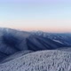 Aerial Flying Above Winter Forest in Mountain Valley at Sunrise - VideoHive Item for Sale