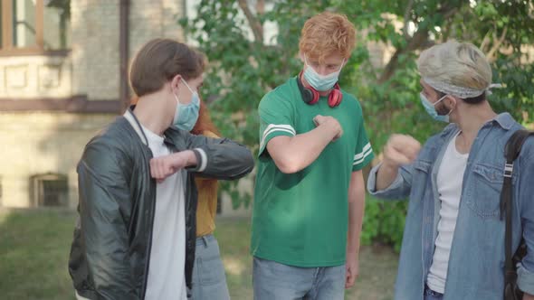 Group of Young People Touching Elbows Instead of High-five and Laughing. Caucasian University alt