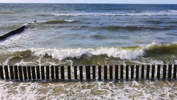 The Waves of the Baltic Sea are Breaking on the Breakwaters Slow Motion alt