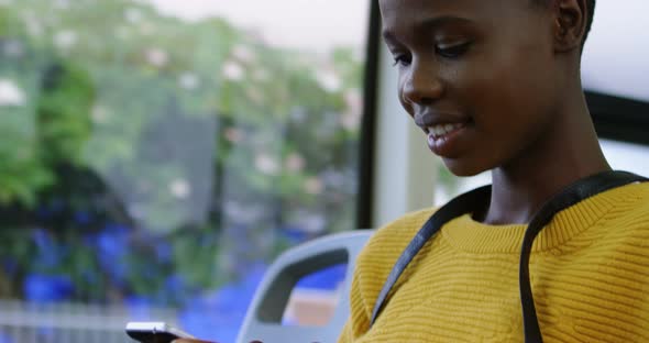 Woman using mobile phone while travelling in bus 4k alt