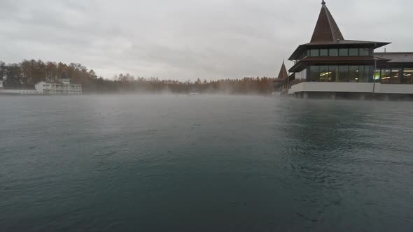Thermal Lake With Rising Steam And Rain