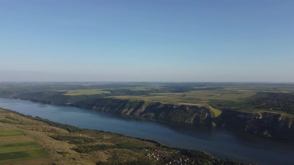 Aerial view of wide Dnister river and distant rocky hills in Bakota area, part of the National park,