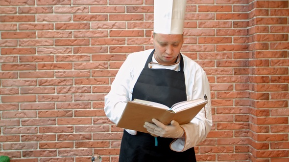 Chef cook holding recipes book thinking what to cook