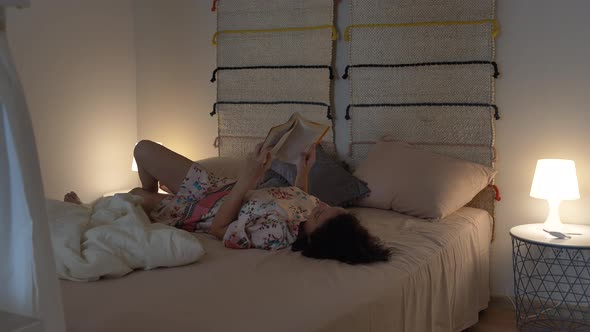 Lying Woman in Bedroom with a Book