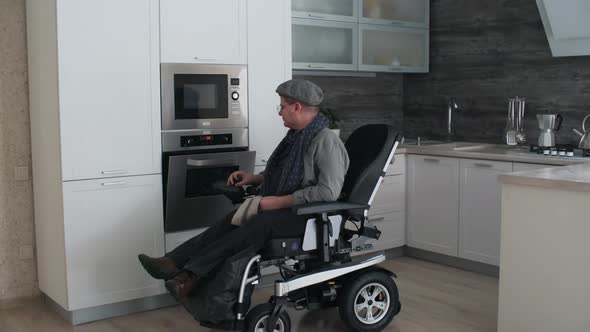 Man in Wheelchair Using Oven alt
