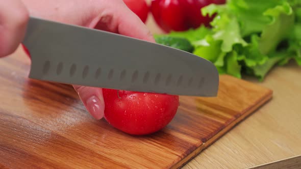 A Female Chef in a White Uniform and a Black Apron in the Restaurant Kitchen alt