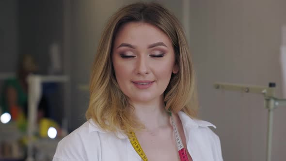 Porteit of Young Beautiful Light Hair Designer in the Workplace alt