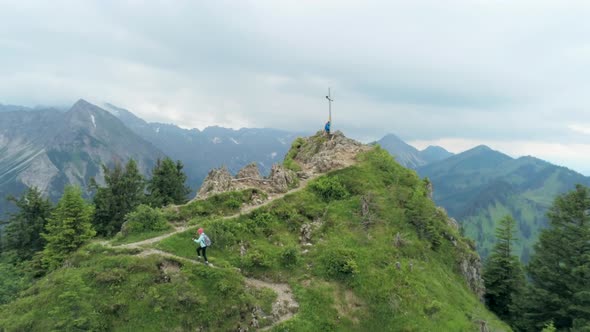 Aerial View of Hiking Woman Climbing To Mountain Peak in Summer in Alps, Germany